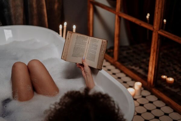 Woman relaxing in bath tub enjoying self-care.